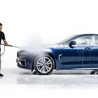 SKKS expert using high pressure washer on a luxury blue car for exterior cleaning