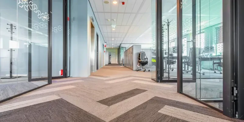 SKKS professional office carpet cleaning service showing a spotless commercial patterned carpet in a modern corporate corridor