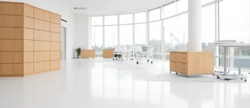 SKKS large office deep cleaning service showing a massive pristine open workspace with gleaming white floors and dust free wooden cabinets